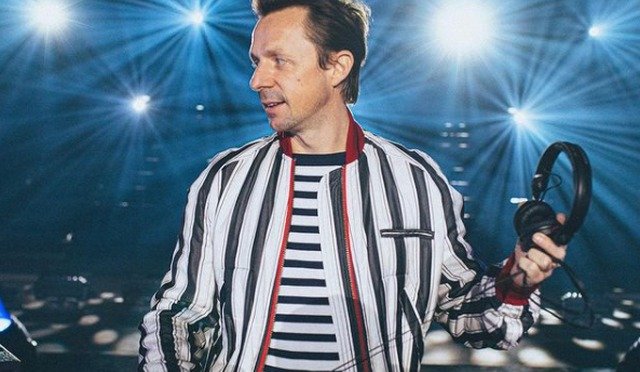 Martin Solveig DJ set, smiling in a striped jacket with headphones in hand, celebrating his 50th birthday with the free single "Fifty"