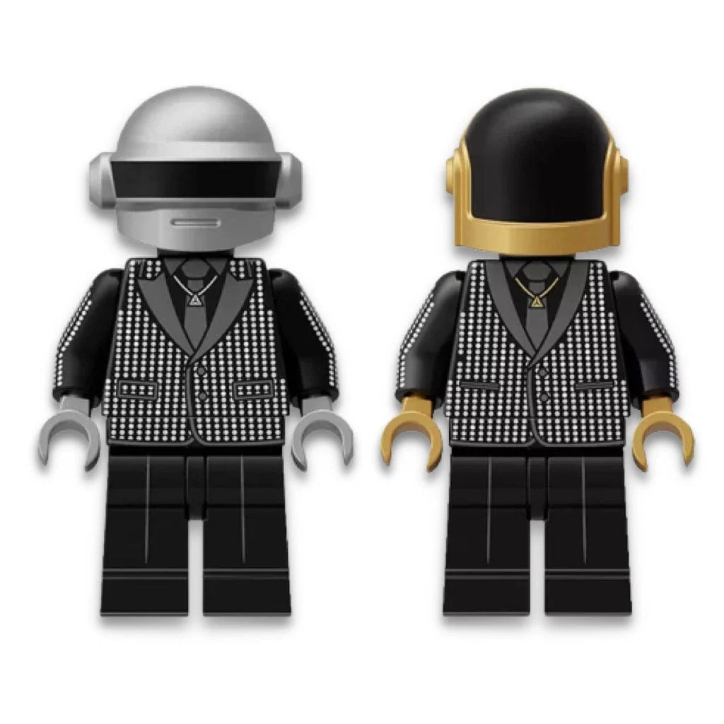 Two Daft Punk LEGO minifigures in sparkling jackets, one with a silver helmet and one with a gold and black helmet, on a white background
